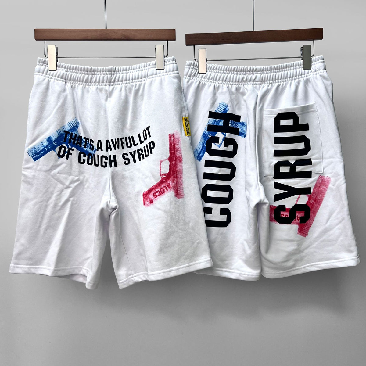 COUGH SYRUP White Graphic Shorts